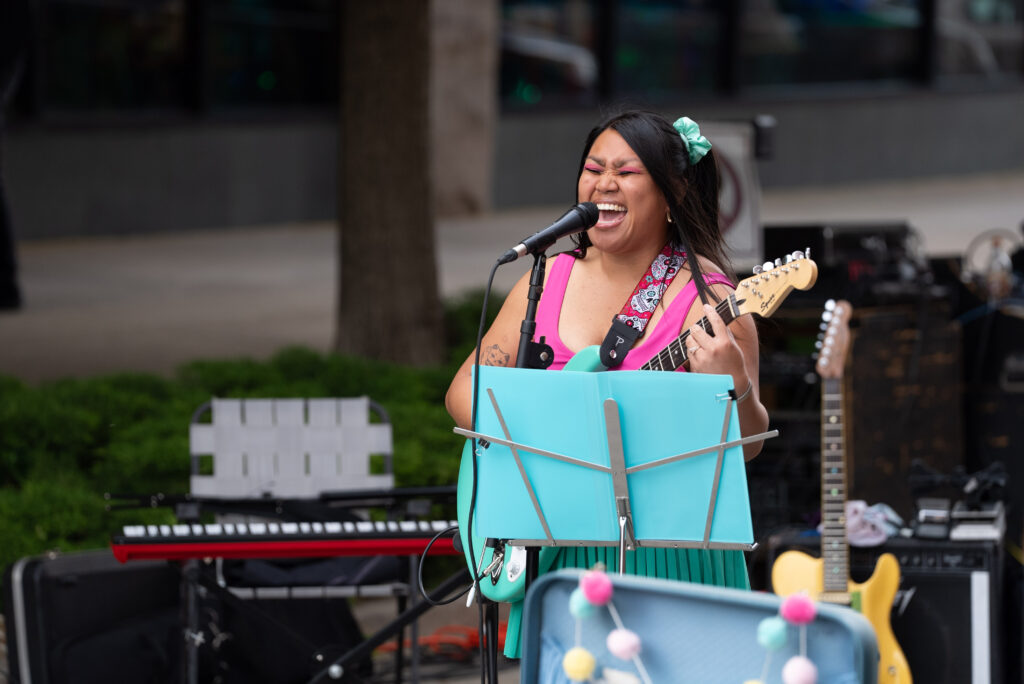 woman playing a guitar and singing